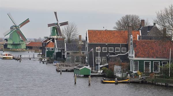 Windmills and green wooden houses along the Zaan river, Zaanse Schans