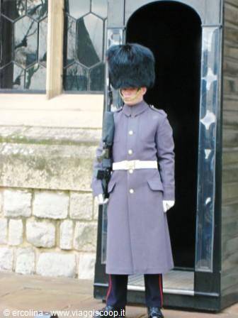 Royal guard in bearskin cap with rifle, sentry beside the sentry box at Windsor