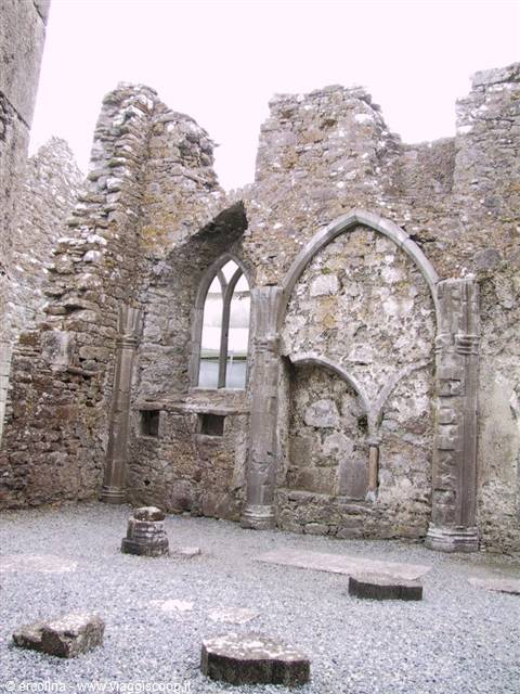 Gothic arches and stone fragments inside medieval ruins