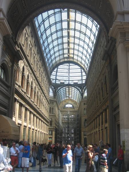 Visitors beneath the glass and iron vault of Galleria Umberto I, Naples