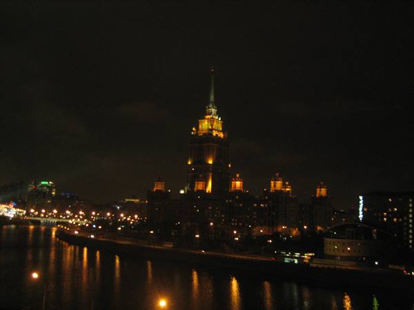 Moscow's Hotel Ukraina lit up at night above the Moskva River