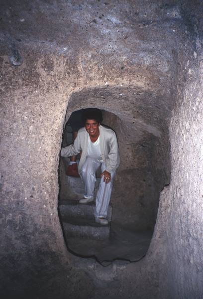 Smiling man at top of rock-carved steps, Cappadocia