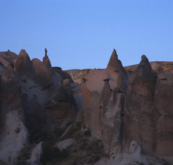 Fairy chimneys in Goreme, Cappadocia, volcanic rock under moonlight
