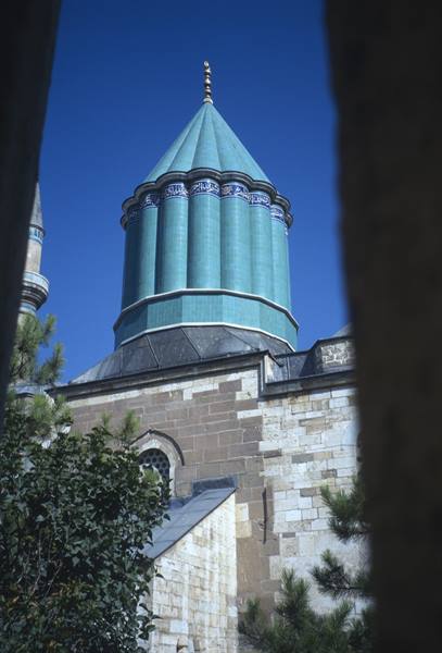 Green tiled tomb of Mevlana in Konya, framed by walls