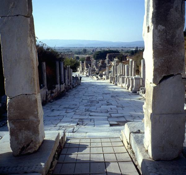 Ephesus: marble-paved street flanked by ancient columns in sunlight