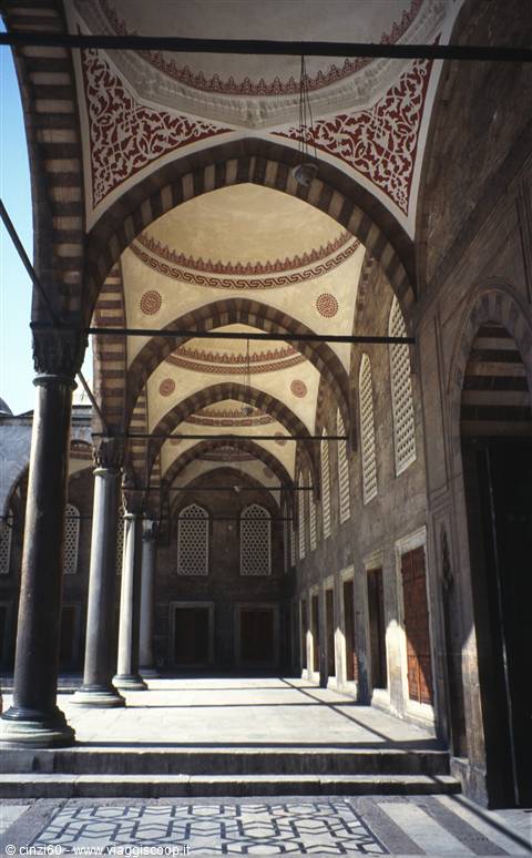 Mosque portico in Istanbul, red-painted arches and marble columns