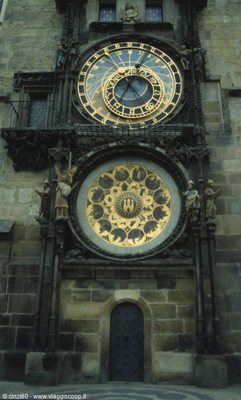 Medieval astronomical clock with golden dials on the stone facade in Prague