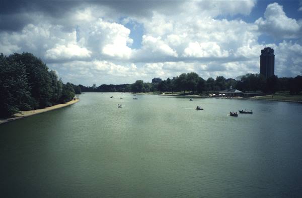 Boats on the Serpentine lake in Hyde Park, London, under heavy clouds
