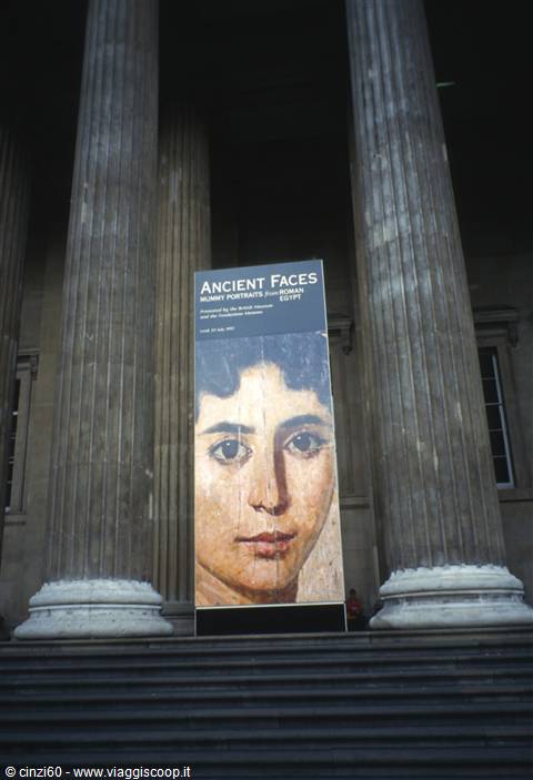 Stone columns of the British Museum with an Ancient Faces exhibition banner