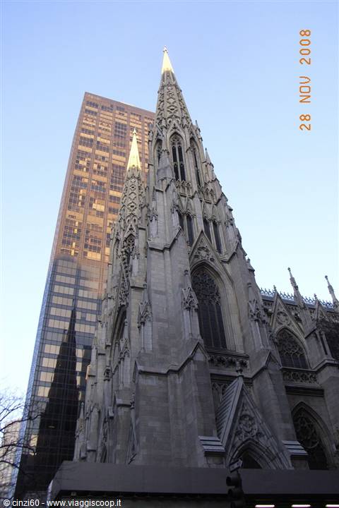 White marble Gothic spires of St. Patrick's Cathedral rising among skyscrapers