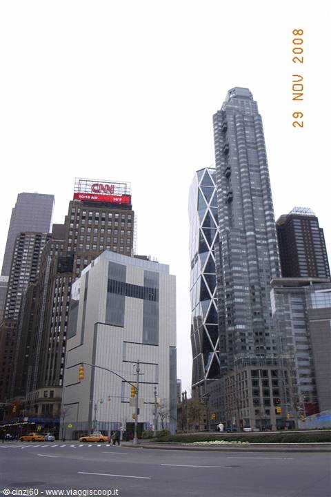 Skyscrapers at Columbus Circle New York with CNN sign and yellow taxis