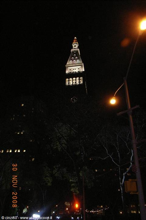 Night in New York: the illuminated Met Life tower above Madison Square trees