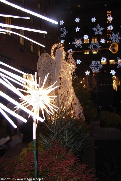 Illuminated angel with trumpet and glowing snowflakes at Rockefeller Center at Christmas