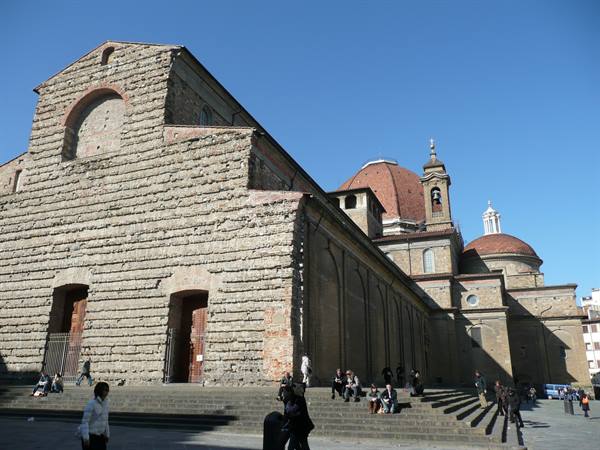 Basilica of San Lorenzo in Florence, people sitting on the steps under blue sky