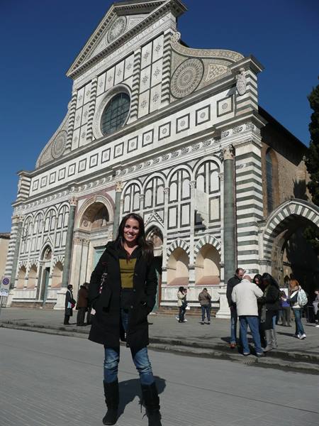 Smiling woman in front of the marble facade of Santa Maria Novella, Florence
