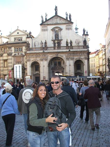Couple with backpack in front of the Salvator Church in Prague