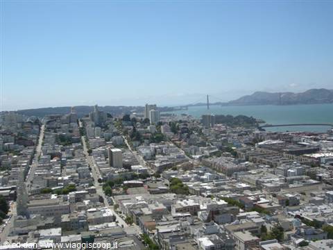 San Francisco rooftops descending toward the bay, Golden Gate Bridge in the distance