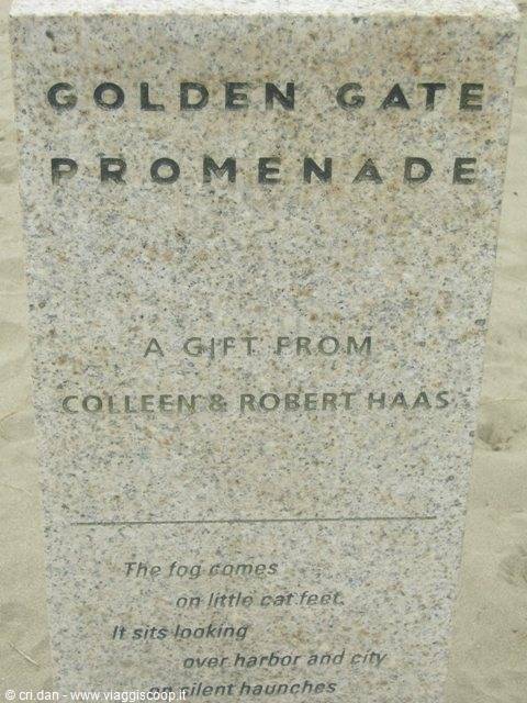 Granite marker inscribed Golden Gate Promenade standing on the sand