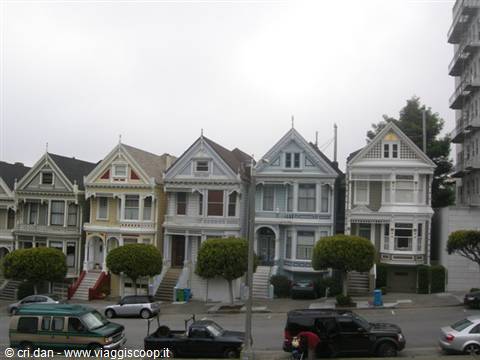 Victorian Painted Ladies houses in San Francisco, gray sky, parked cars