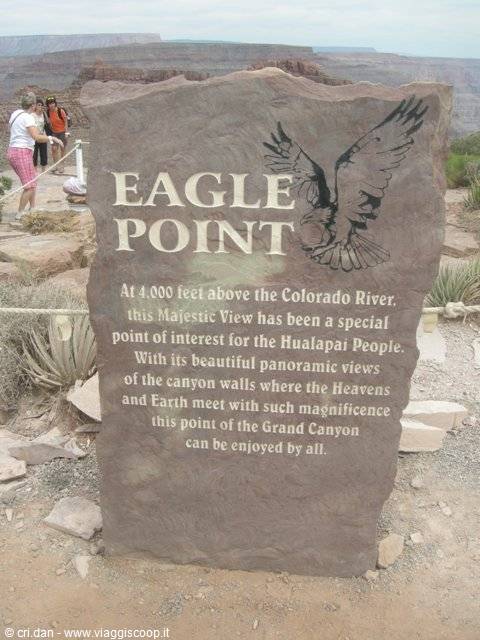 Inscribed eagle stone at Eagle Point, Grand Canyon, tourists in daylight