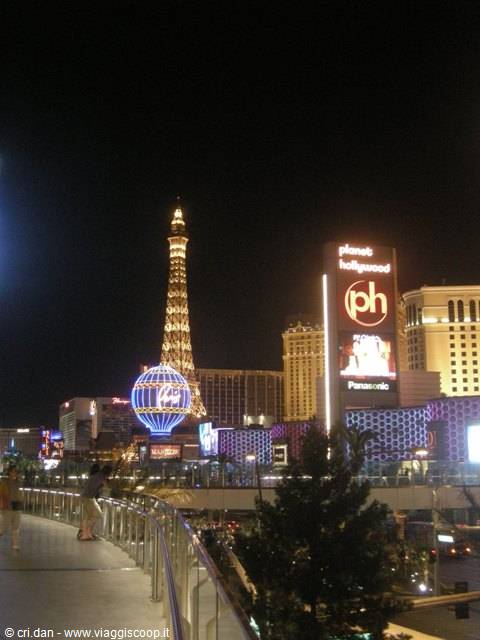 Las Vegas at night: Paris hotel's illuminated Eiffel Tower and Planet Hollywood globe
