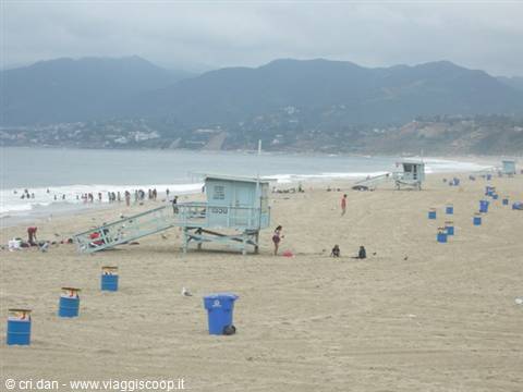 Lifeguard tower on sandy beach with blue bins, Santa Monica