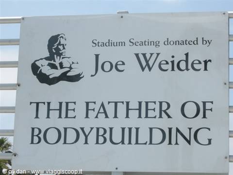 White stadium sign honoring Joe Weider, donor of the seating
