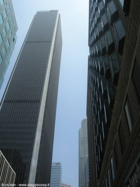 Dark glass skyscrapers towering over downtown Los Angeles under a grey sky