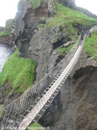 Carrick-a-Rede rope bridge swaying between grassy cliffs