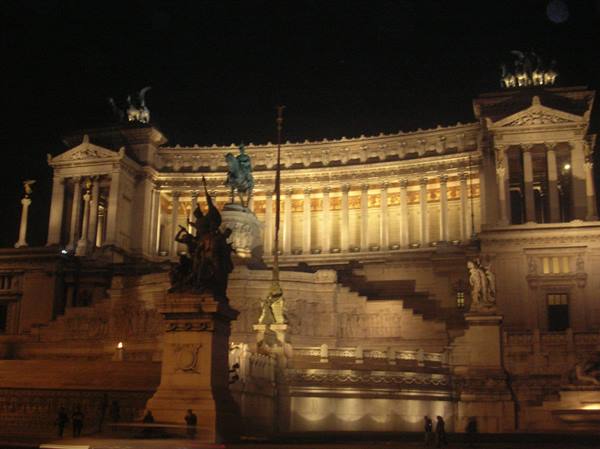 Victor Emmanuel II Monument lit at night in Rome, equestrian statue visible