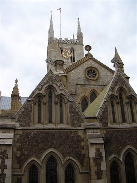 Southwark Cathedral in London, gothic stone and flint facade with clock