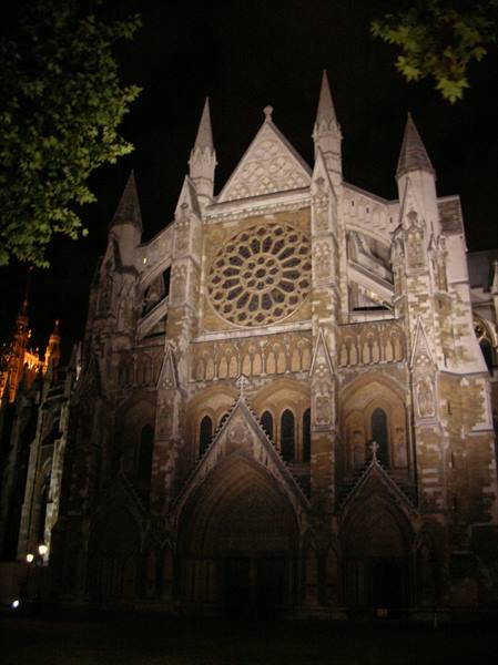 Gothic facade of Westminster Abbey at night with illuminated rose window