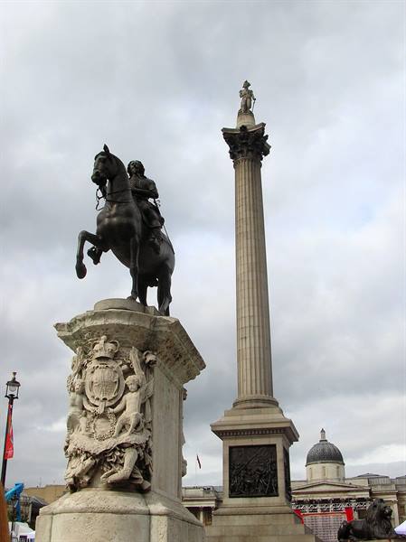Bronze equestrian statue and Nelson's Column in Trafalgar Square, cloudy sky