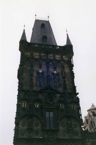 The Powder Tower in Prague, dark gothic stone against a grey sky