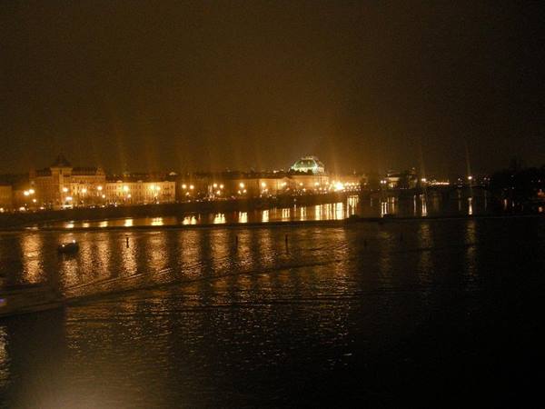 Night on the Vltava in Prague, building lights reflecting on dark water