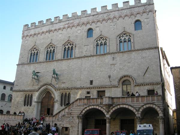 Tourists in front of Palazzo dei Priori in Perugia, Gothic stone facade