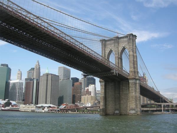 Brooklyn Bridge in stone and steel over the East River, Manhattan skyscrapers