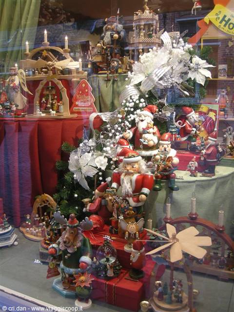 Christmas shop window with wooden Santa Claus figurines, candles and ornaments