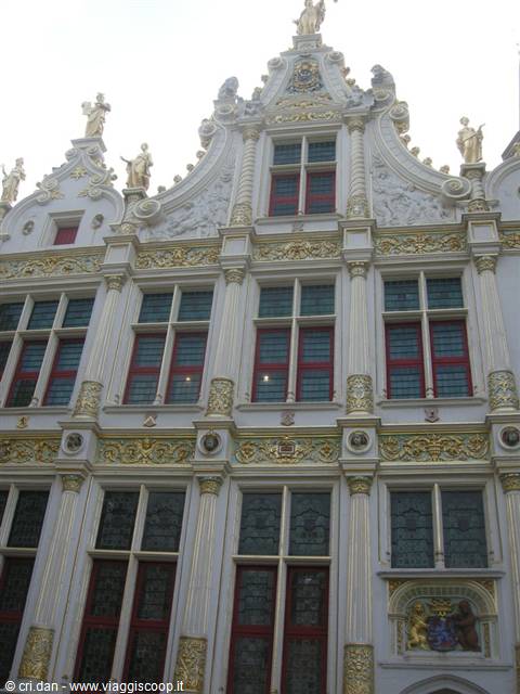 baroque facade with gilded statues and windows in Bruges