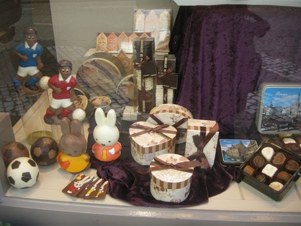 Chocolate shop window with gift boxes, pralines and footballer figurines