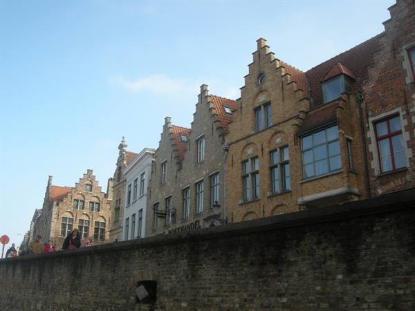 Brick facades with stepped gables along a canal in Bruges