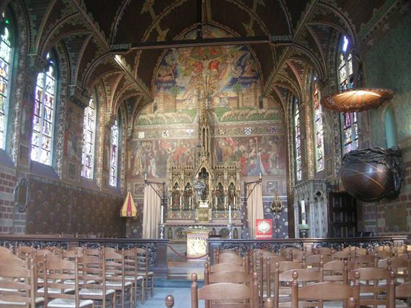 Interior of the Basilica of the Holy Blood in Bruges, neo-Gothic altar among painted stained glass