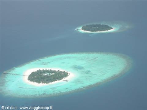 Coral islands with turquoise lagoon and ring reef seen from above, Maldives