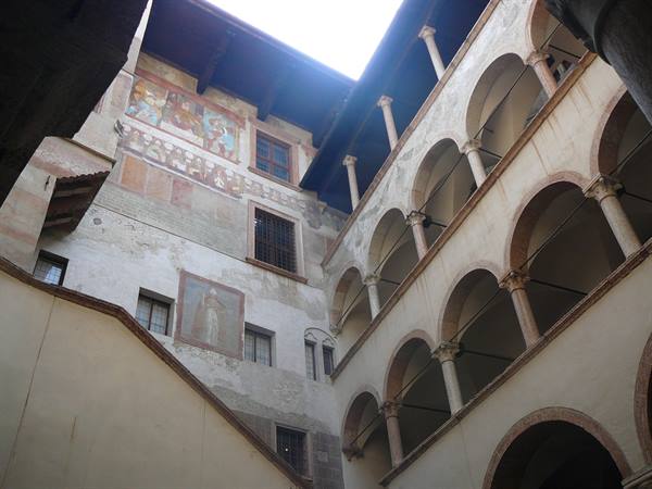 Frescoed courtyard with arched loggia at Castello del Buonconsiglio