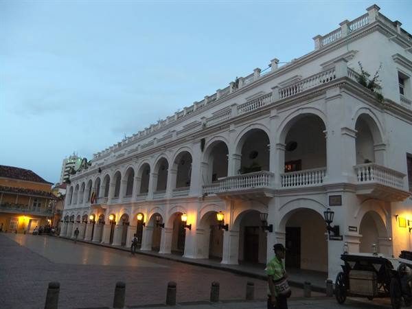 White colonial arcades lit at dawn on Plaza de los Coches, Cartagena