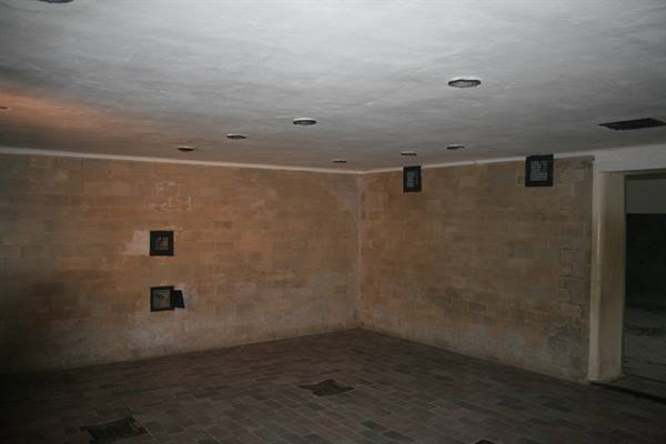 Empty room with brick walls, recessed ceiling lights and wall vents