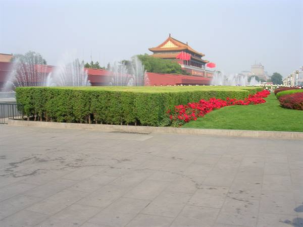 Fountains, hedges and red flowers in front of Tiananmen gate, Beijing