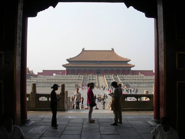 Tourists at the Forbidden City gate, imperial palace hall beyond