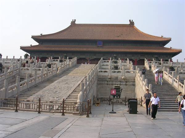Visitors climb marble staircases toward an imperial hall in the Forbidden City