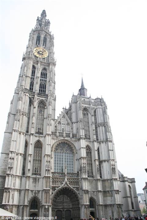 Gothic cathedral of Antwerp, stone facade with ornate tower and golden clock